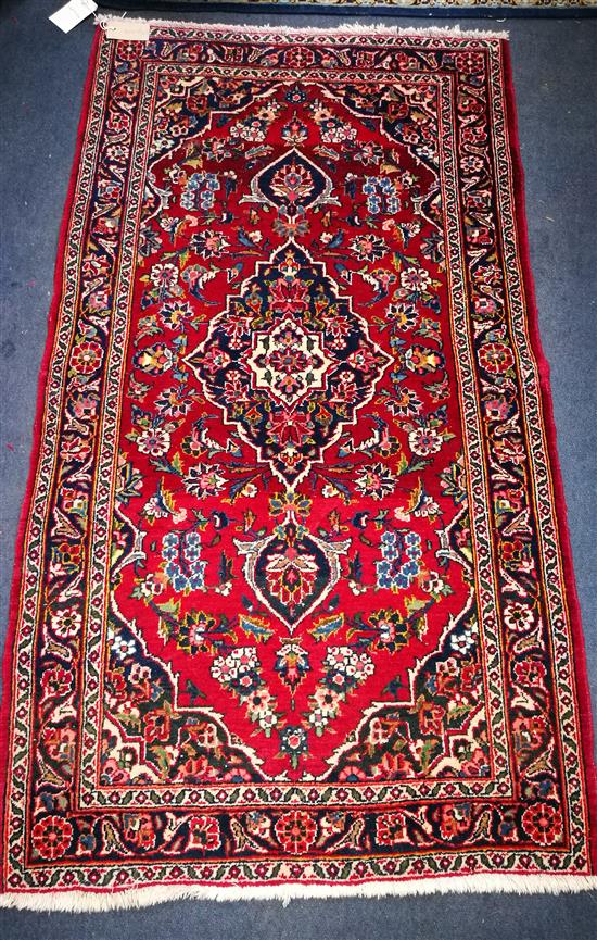 A red and blue ground rug 132 x 70cm